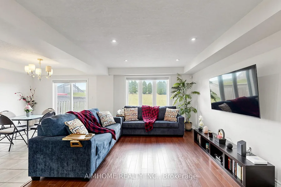 Bright open-concept living room with hardwood flooring