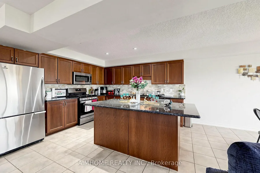 Kitchen with granite island and stainless steel appliances