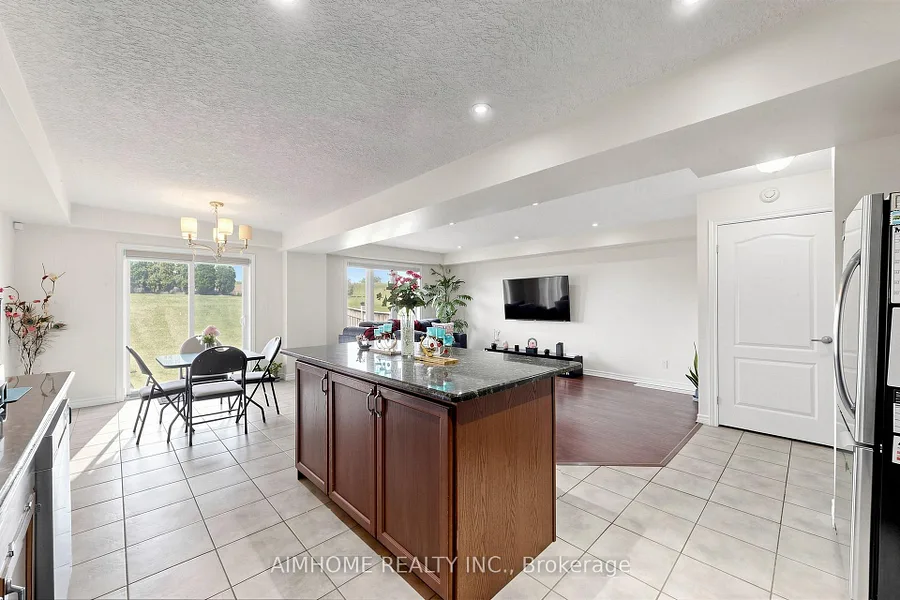 Open-concept kitchen, dining and living area